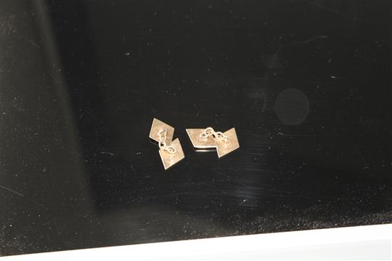 A pair of 9ct and diamond set diamond shaped cufflinks, length of one link 15mm, gross weight 7 grams.